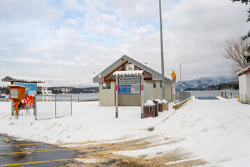 The public change house, life jacket station and boat launch at Honeysuckle Beach, Hayden Lake, Idaho USA, site of many winter slide-offs in the lake.