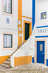 Typical street fragment with blue and yellow colors in the small coastal town in Portugal.