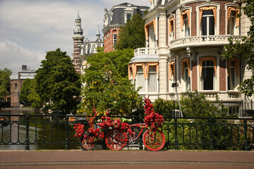 Colorful flower bike on the Museum bridge in Amsterdam over the Singelgracht canal 