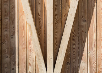 Wooden wall made of light vertical planks. Wood texture background with shadows. Natural pattern.