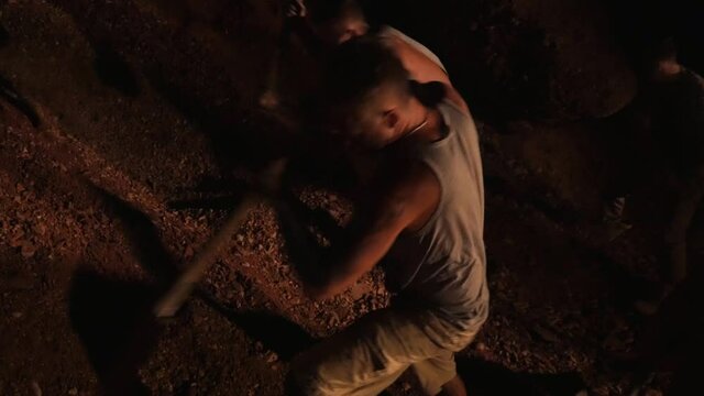 Men mine gold underground. Diamond seekers dig the ground in search of treasures of jewels.