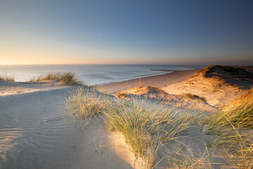 view on beautiful beach and dunes at sunset