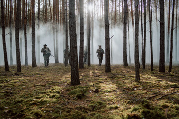 Squad of Four Fully Equipped Soldiers in Camouflage on a Reconnaissance Military Mission, Rifles...