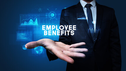 Hand of Businessman holding EMPLOYEE BENEFITS inscription, business success concept