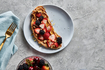 Peanut Butter Berry Honey Toast on Blue Plate with Fruit Bowl