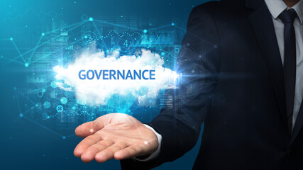 Hand of Businessman holding GOVERNANCE inscription, successful business concept