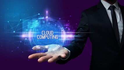 Man hand holding CLOUD COMPUTING inscription, technology concept