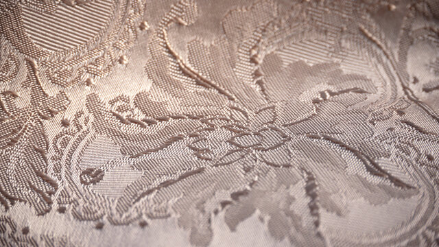 Detalle de bordado floral en tejido brocado jacquard damasco de color beige