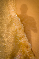 man shadow in a breaking wave