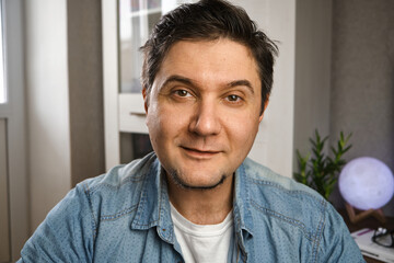 Middle aged man looking at camera making conference video call