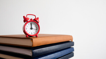 The red clock at the top of the notebooks.