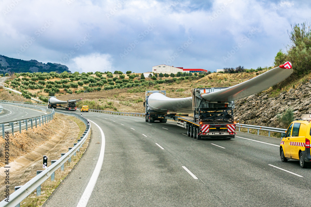 Canvas Prints several special transport trucks on the road transporting wind turbine blades.