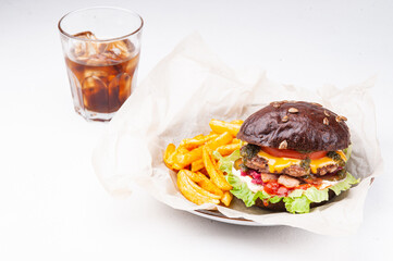 Burger with fries and drink on white background