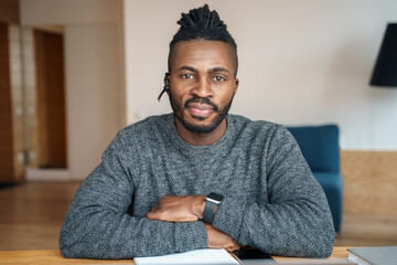 Portrait of happy smiling nice looking African American man wearing headset.