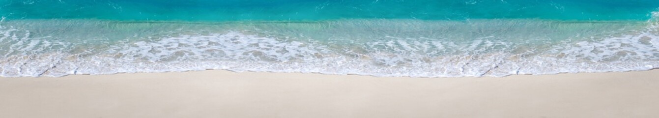 Fototapeta na wymiar Sea waves with foam on white tropical beach. Long banner.
