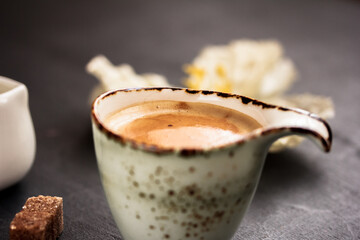 Rustic coffee mug on dark background. Selective focus