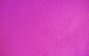Abstract grainy texture on magenta wall. It can be used as a design element and background