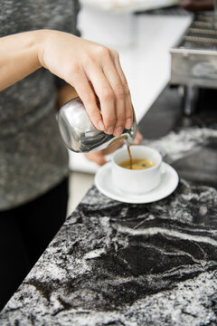 Close Up Female Barista Pouring Espresso Shot Into Cup