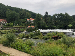 Waterfall into greenery in Galicia