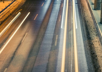 Cars passing on the highway under the bridge in winter
