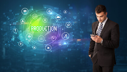 Businessman thinking in front of technology related icons and PRODUCTION inscription, modern technology concept