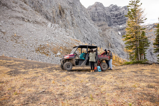 Women preparing for hike at UTV in rugged scenic autumn mountains