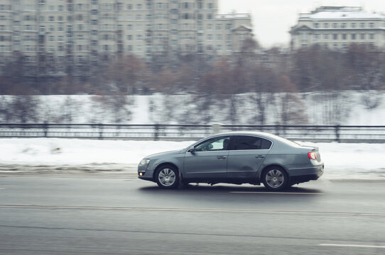 A man drives jetta at high speed on winter street. Car drives fast through the city with motion blur effect. excess speed limit