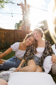 Portrait Happy Carefree Teenage Girl Friends In Sunny Summer Backyard