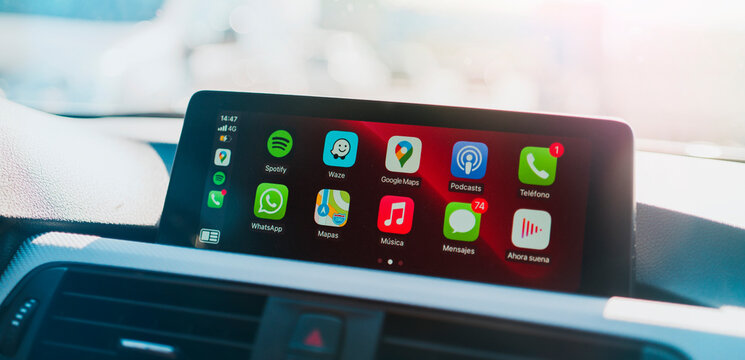 MADRID, SPAIN - MAY 15, 2020: Details of Apps and icons on the the Apple CarPlay main screen in modern car dashboard during driving