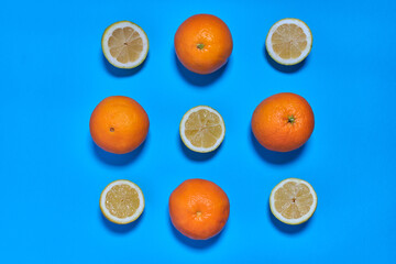 Whole and split oranges on a blue background. CITRUS CITRIC
