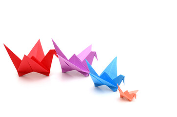 A follow teamwork origami birds on white