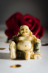 Fat Buddha with a red Rose.