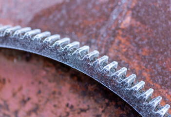 An element of a steel toothed sector covered with frost, on a frosty day,close-up.