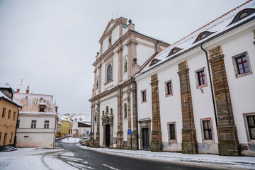 The Augustinian baroque monastery with the Basilica of All Saints, abbey in Bohemia under snow in...