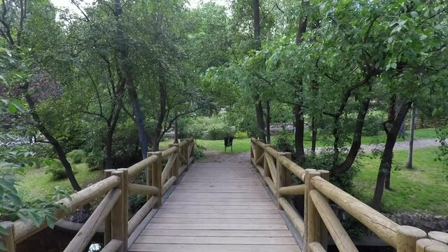Walking on a wooden bridge at El Retiro park in Madrid