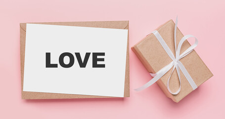 Gifts with note letter on isolated pink background, love and valentine concept with text love