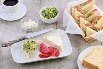 Wheat toast sandwich with cream cheese with microgreen alfalfa sprouts and salami. Healthy and fresh food.