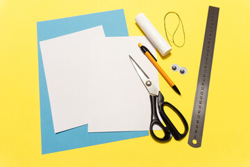 How to make a paper rabbit for Easter greetings. DIY children's art project. DIY concept. Step 2. Cut the white sheet into 2 pieces