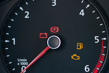Natural light. the dashboard of the car. The engine error indicator lights up on it. Close-up.