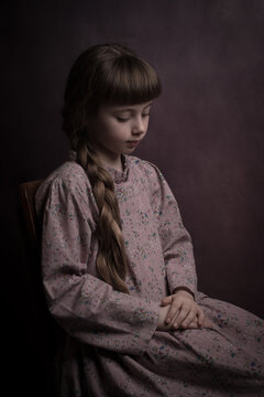 Girl with long braided hair sitting and relaxing in purple vintage dress on chair in dark painterly renaissance style
