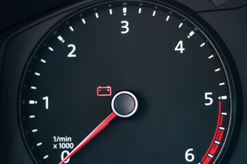 Fototapeta premium Natural light. the dashboard of the car. The battery indicator is on. Close-up.