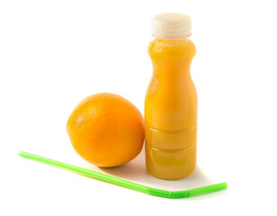 bottle with orange juice and an orange, straws lying nearby, isolated on white background, healthy food.