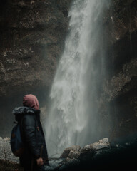 A man looking at a waterfall