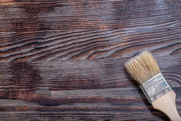 Paint brush on a wooden background