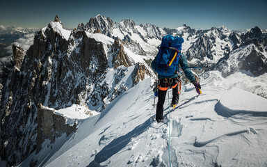 Man climbing through the mountains on snow and glacier