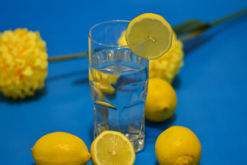 Lemon Water on Blue Background