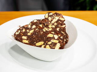 Chocolate salami in a plate, close up
