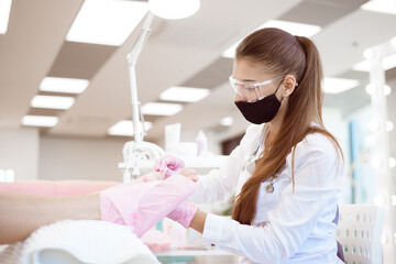 Woman feet receiving pedicure in a Day Spa