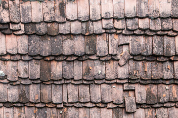 Wooden tiles on the antique roof. Background and texture