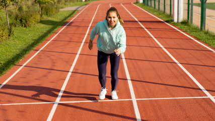 Training on the street, a young female athlete makes a workout on the street platform.